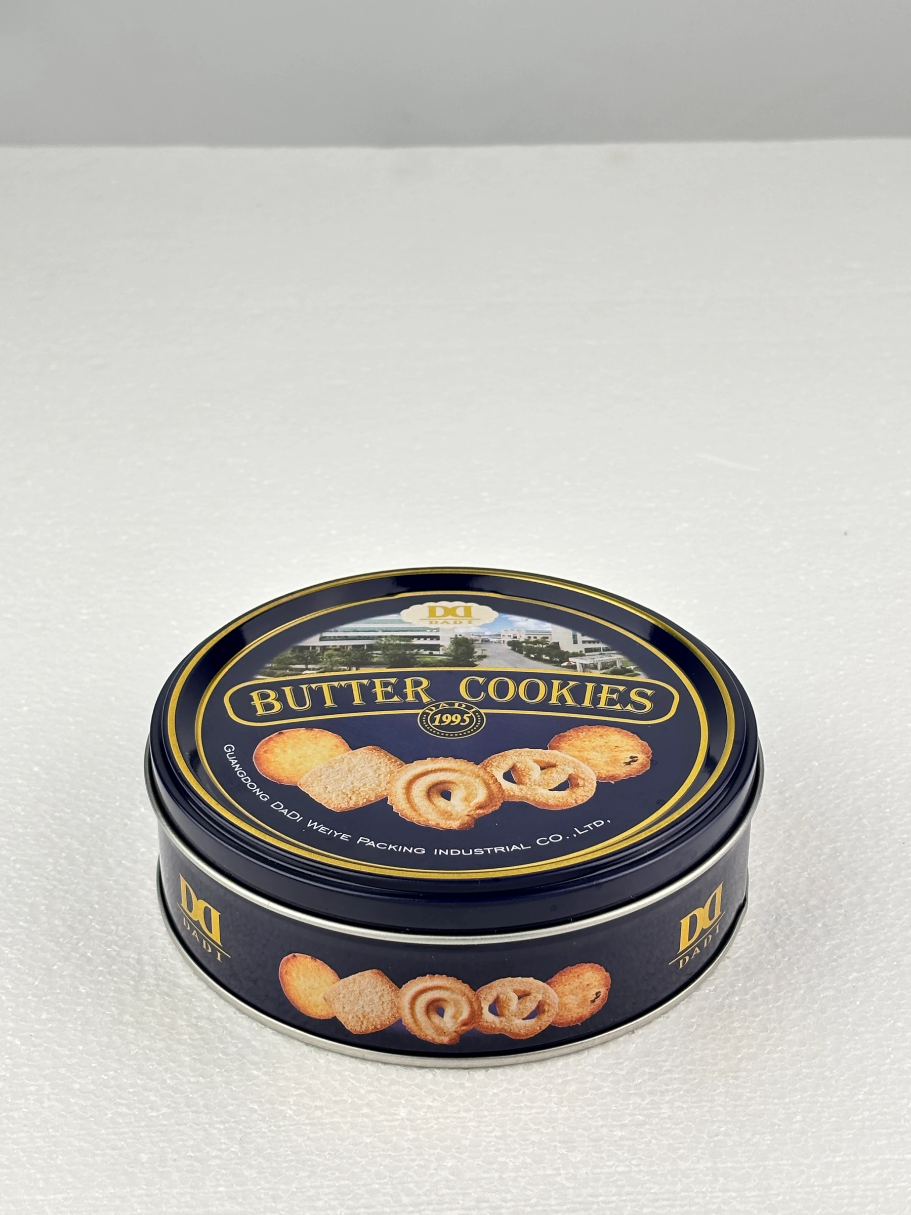 Blue round cookie tin shown upright