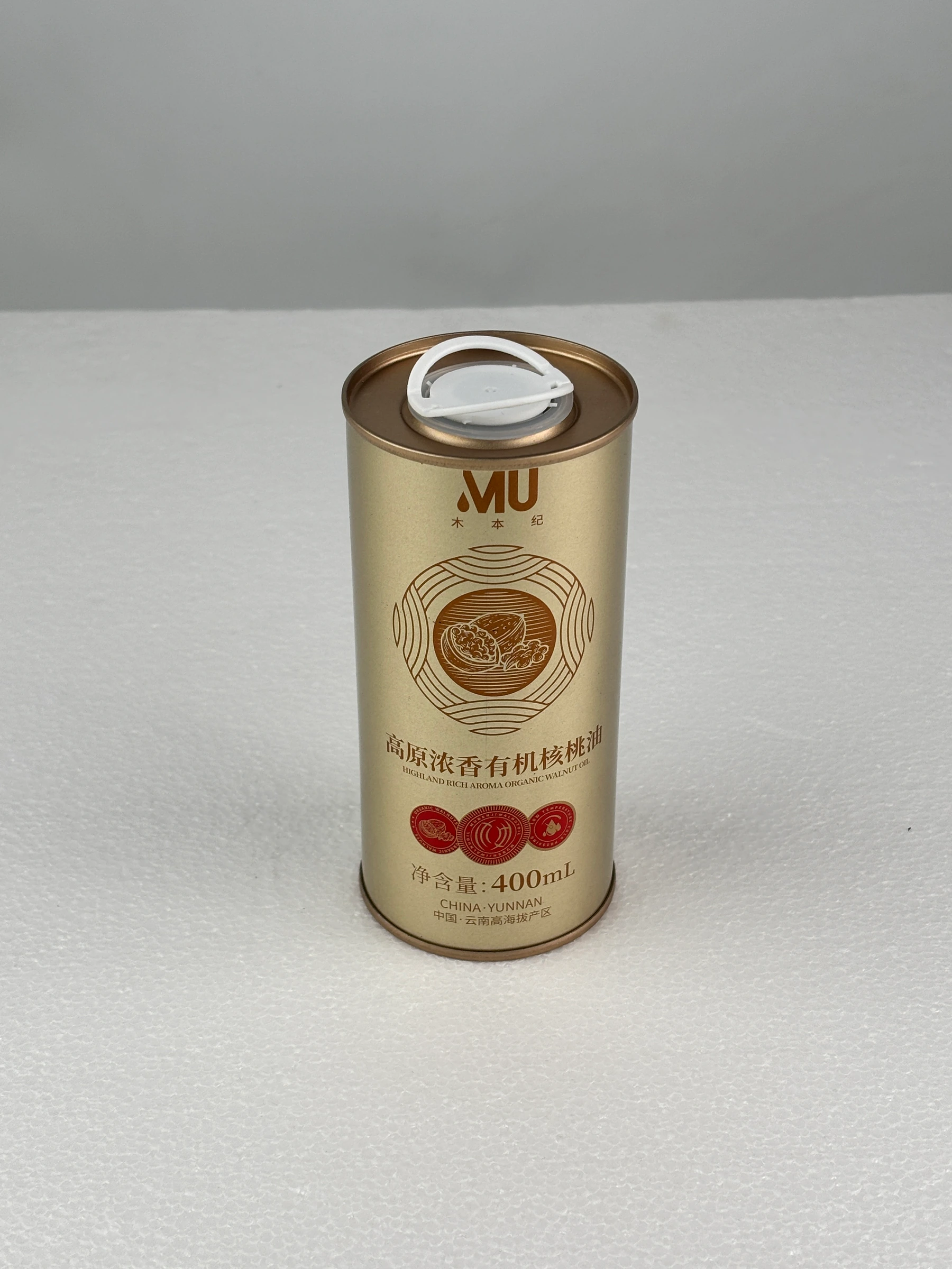 Light gold cylindrical oil gift tin